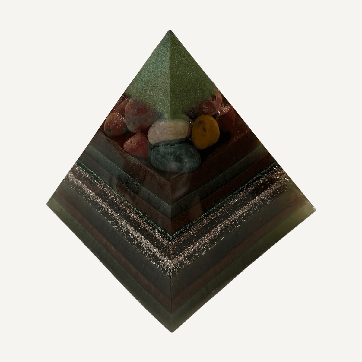 Green layered resin pyramid with colorful tumbled stones near the peak