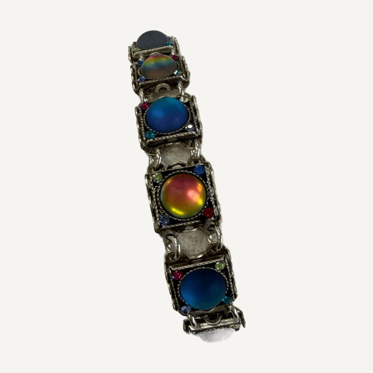 Iridescent sunset-orange cabochon link among blue links