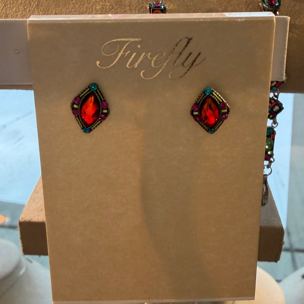 Orange-red crystal stud earrings on a FireFly card on a display stand
