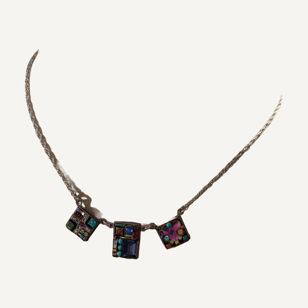 Three square mosaic crystal stations necklace on a beige velvet bust