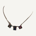Three square mosaic crystal stations necklace on a beige velvet bust